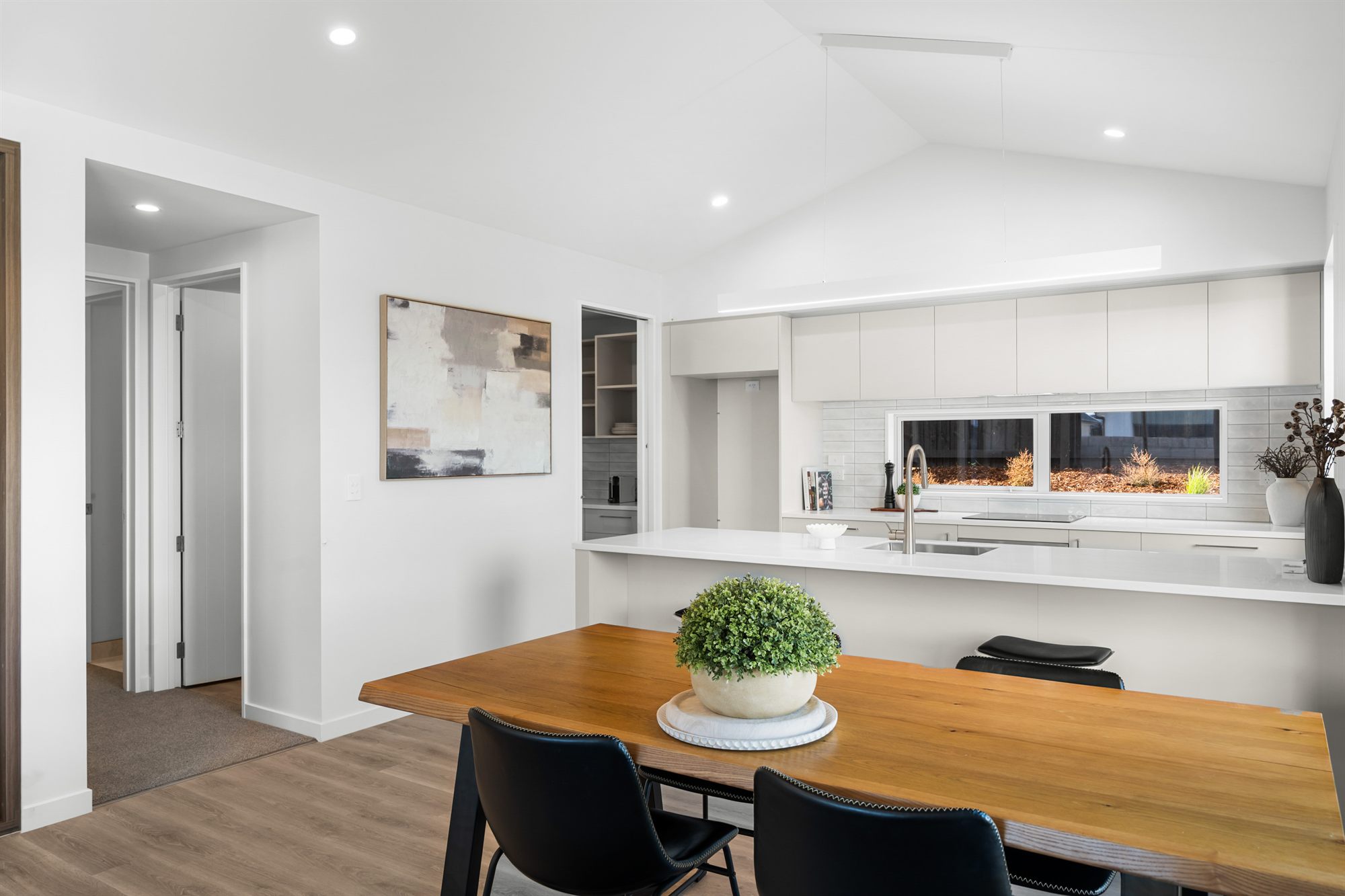 Open-plan kitchen and dining at an Elmbridge Mews home — raised ceilings, Trendz kitchen, north-facing light