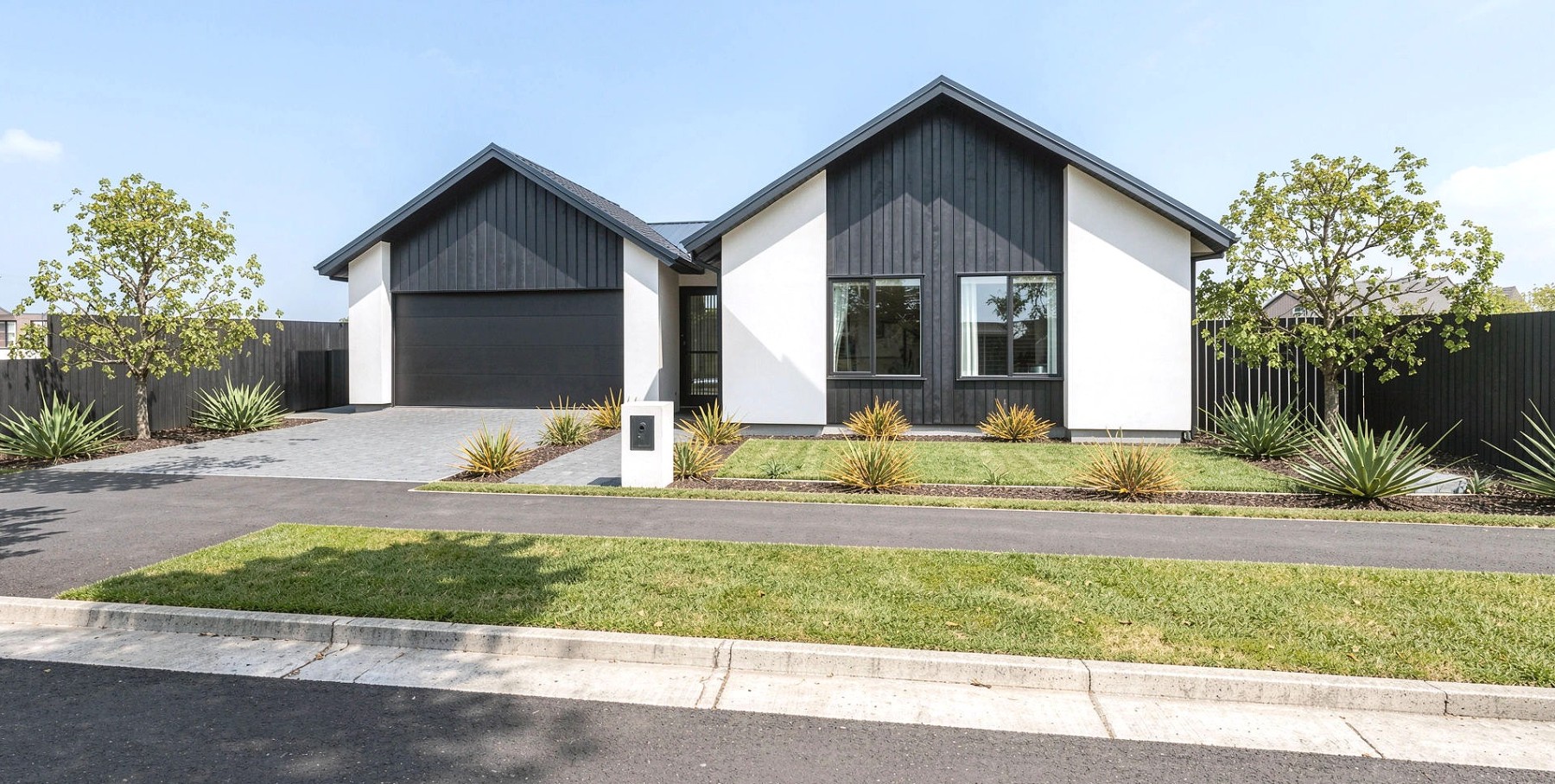 Single-storey home, dark cedar and white render, street frontage